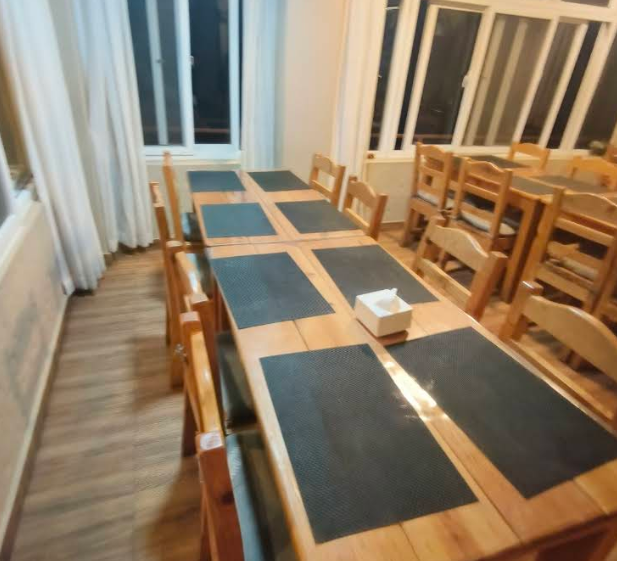 The warm wood-set dining room of Royal View Inn