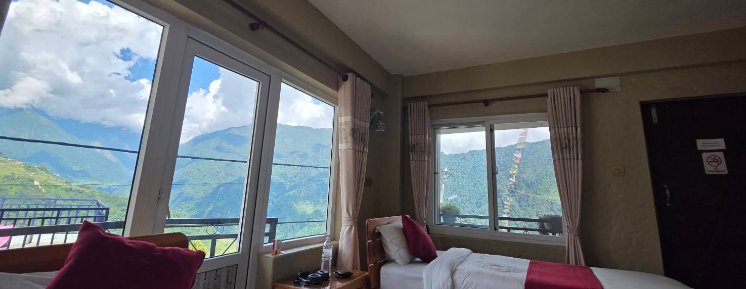 A room at Royal View Inn opening onto the green Annapurna valley